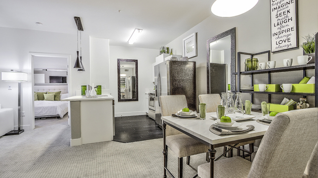 Evolve Apartments - Apartment Dining Room with Green & White Furnishing and a visible Kitchen & Room.